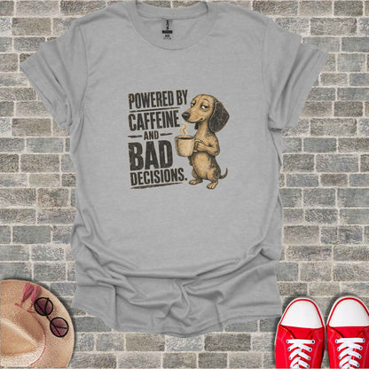 Dachshund holding coffee mug with text "POWERED BY CAFFEINE AND BAD DECISIONS."