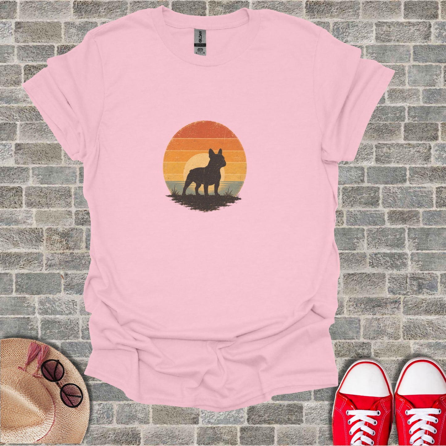 French bulldog silhouette against a sunset on a pink t-shirt.