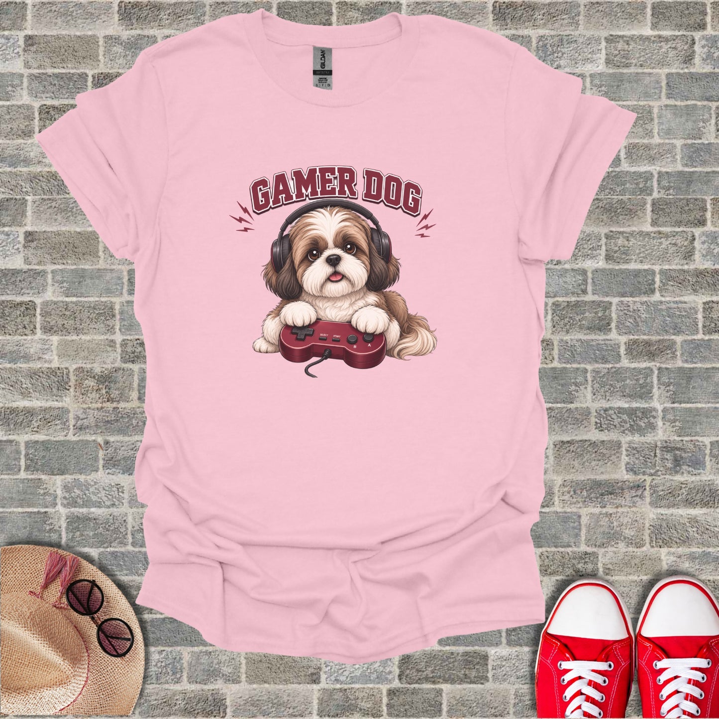 Pink t-shirt with "Gamer Dog" text and illustration of a dog holding a controller.