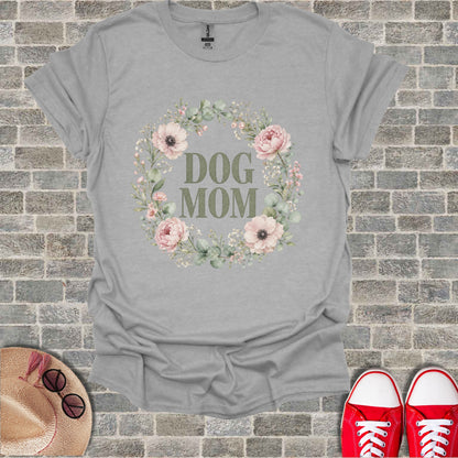 Grey t-shirt with "DOG MOM" text inside a floral wreath.