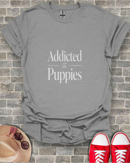 Gray t-shirt with "Addicted To Puppies" text, hat, and red sneakers.