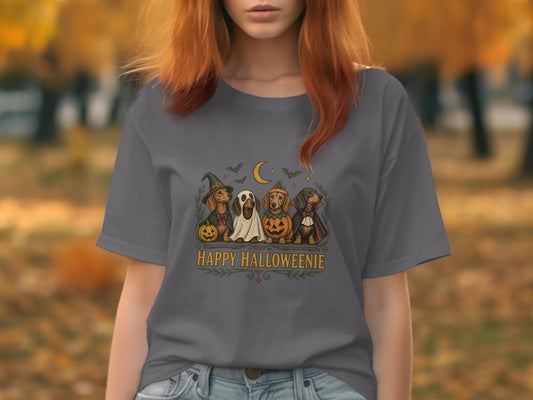 Four dachshunds in Halloween costumes surround text that reads "Happy Halloweenie".