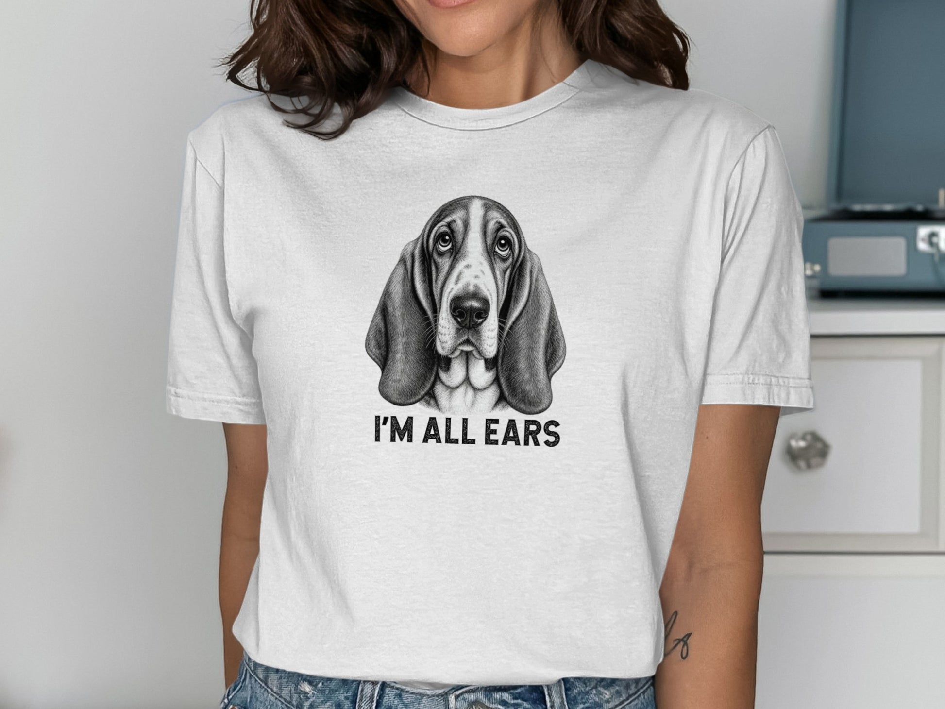 Basset Hound wearing t-shirt that says "I'M ALL EARS."