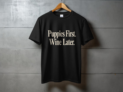 Black t-shirt with "Puppies First. Wine Later." text printed on the front.
