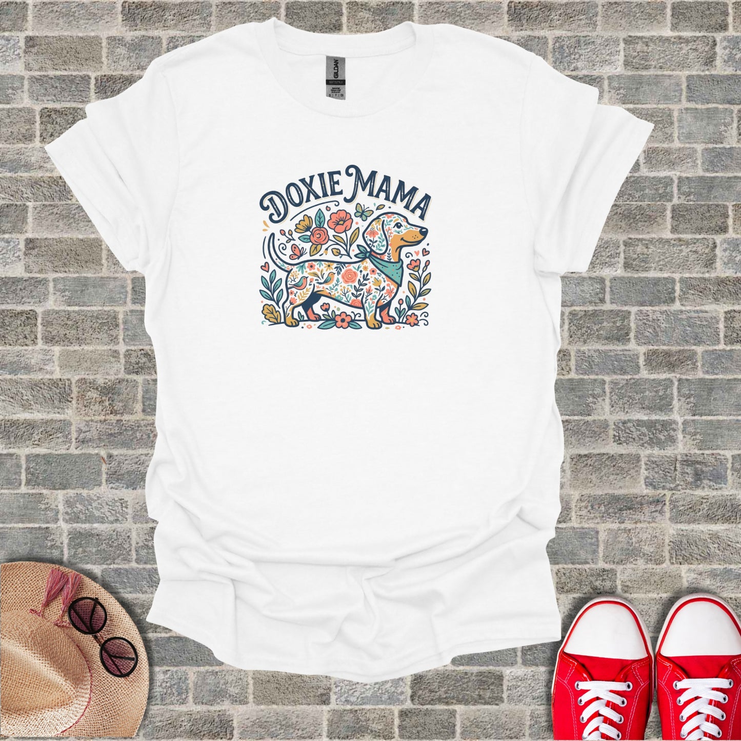 White t-shirt with "Doxie Mama" text and floral dachshund graphic.