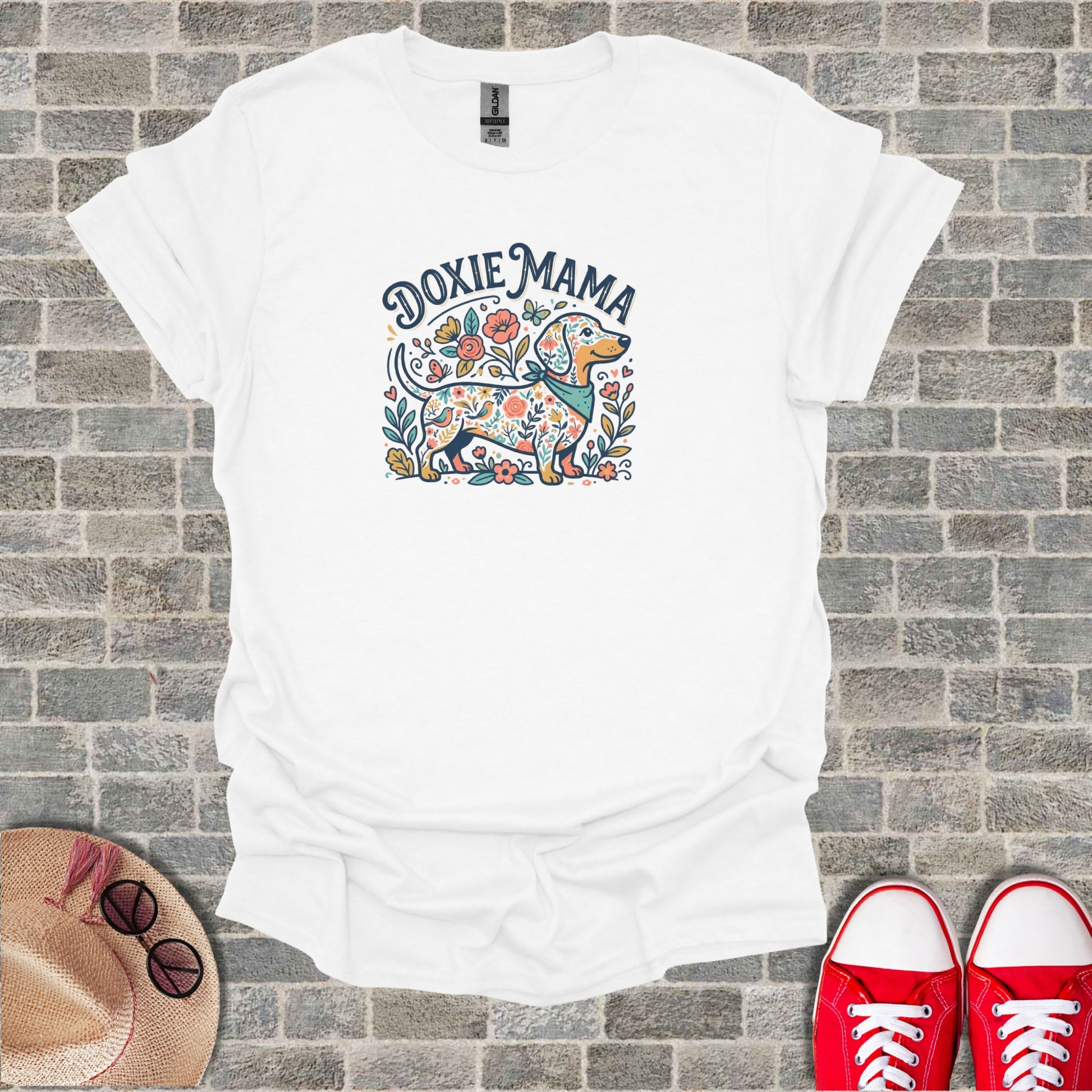White t-shirt with "Doxie Mama" text and floral dachshund graphic.