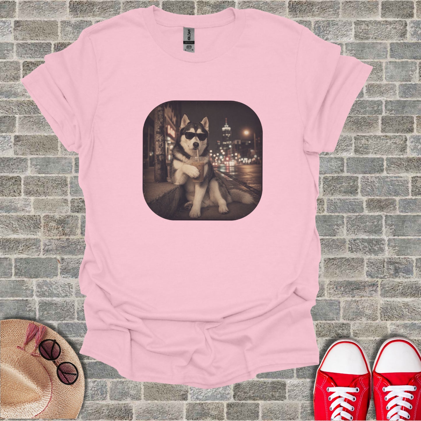 Pink t-shirt with a husky wearing sunglasses drinking a beverage.