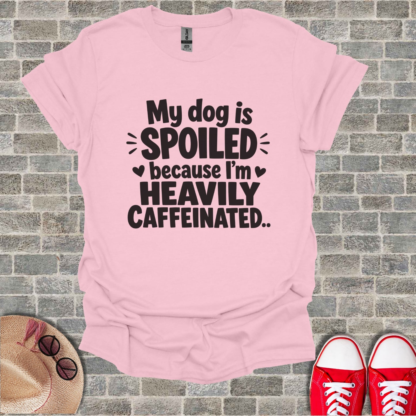 Pink t-shirt with "My dog is spoiled because I'm heavily caffeinated" text.