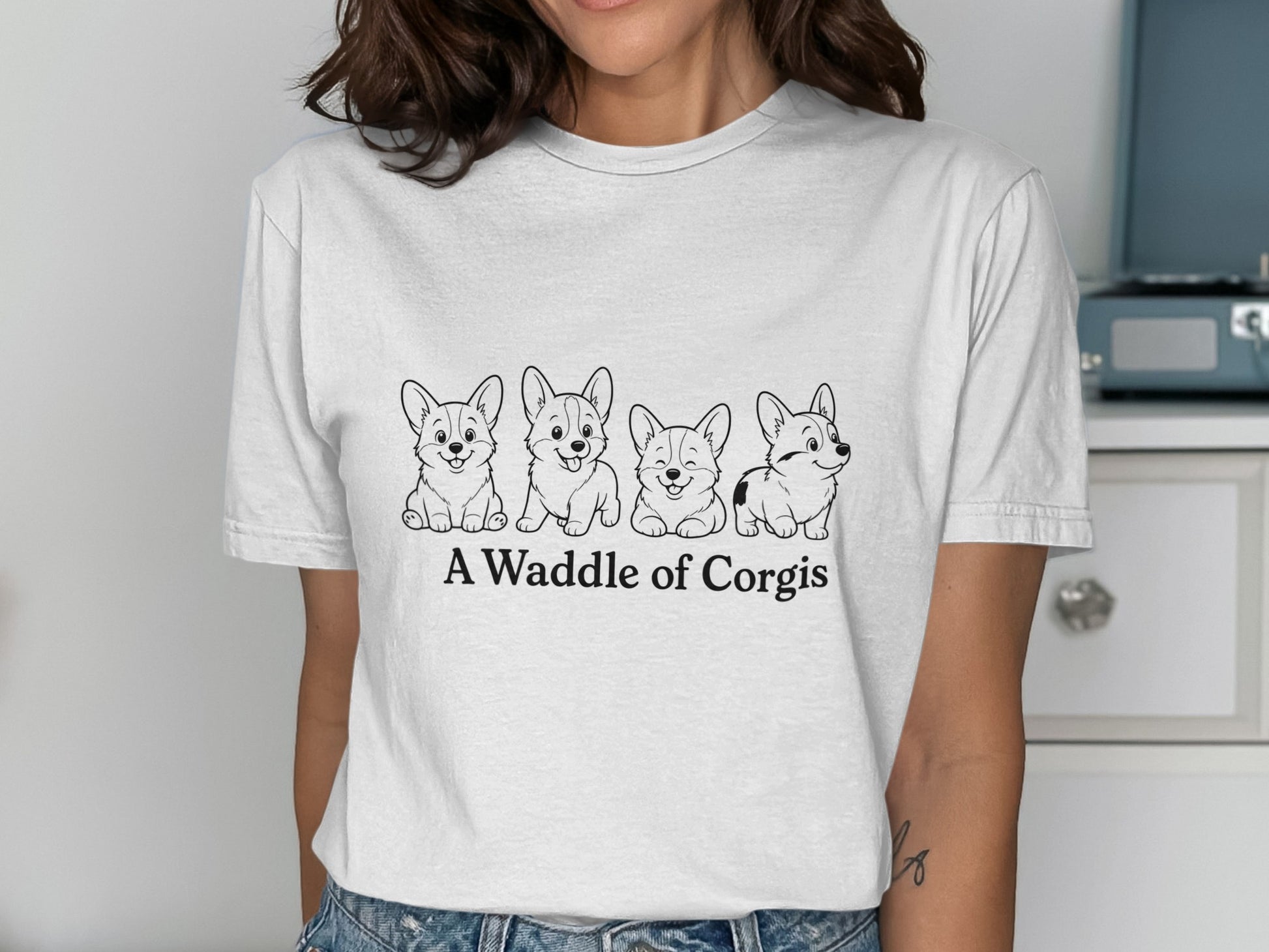 Four cartoon corgis with text "A Waddle of Corgis" on a white t-shirt.