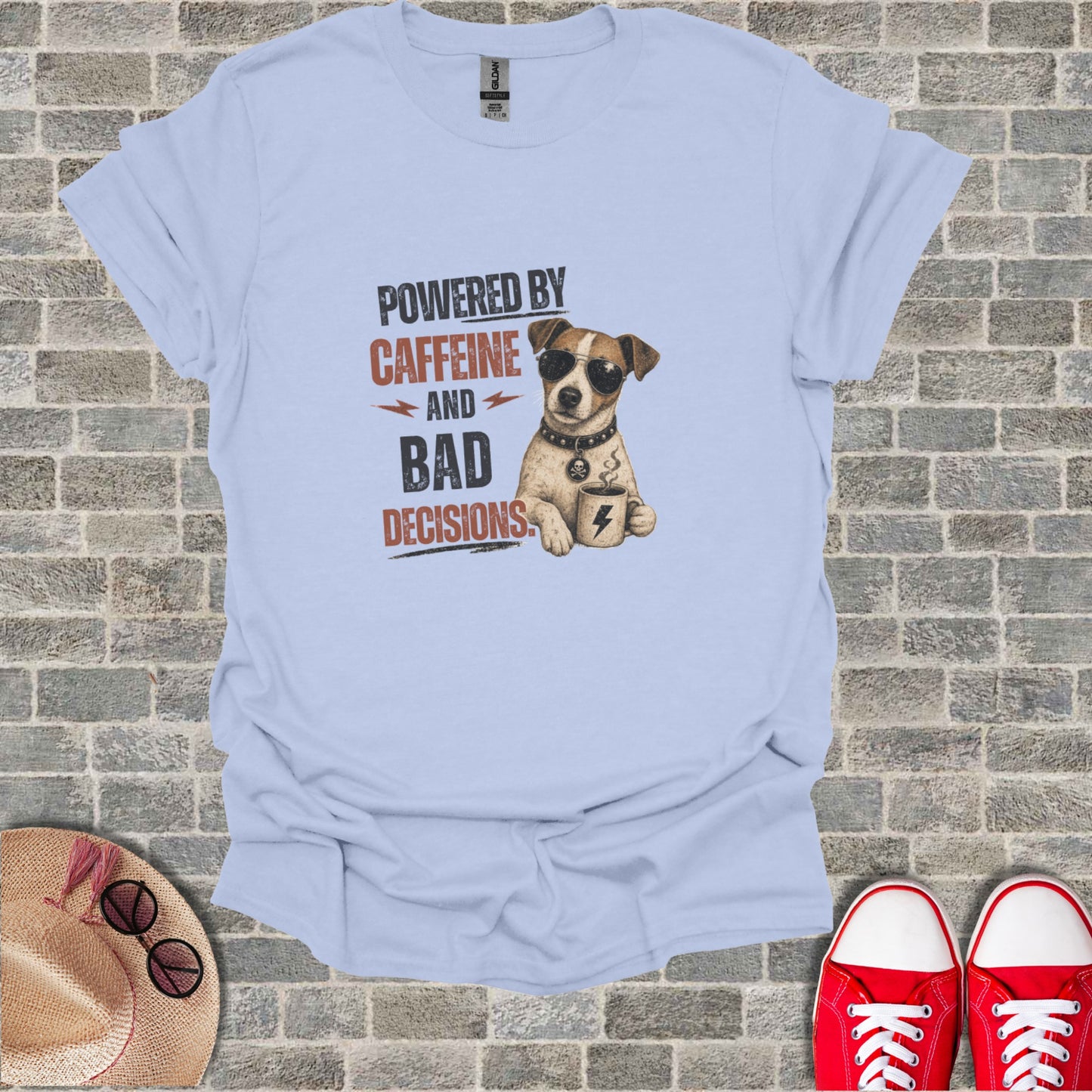 Light blue t-shirt with dog wearing sunglasses and text "POWERED BY CAFFEINE AND BAD DECISIONS".