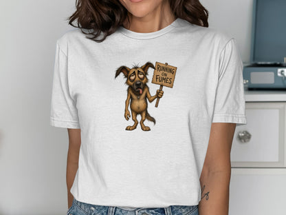 Cartoon dog wearing a t-shirt holding a sign that says "RUNNING ON FUMES".