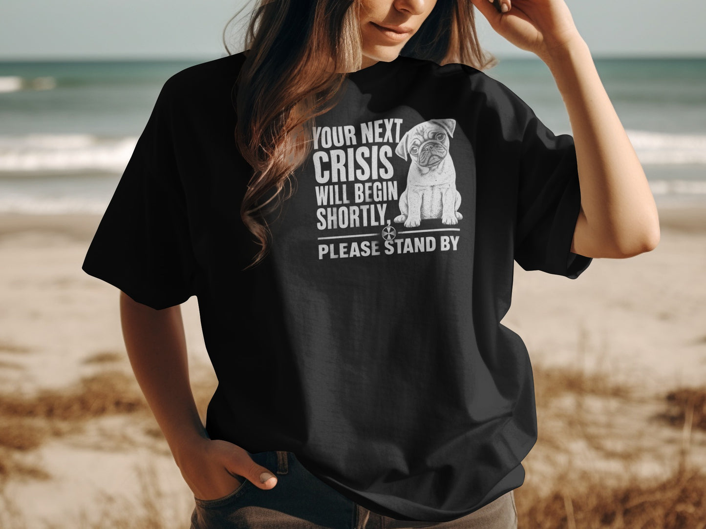 Black t-shirt with a pug graphic and text "YOUR NEXT CRISIS WILL BEGIN SHORTLY, PLEASE STAND BY".