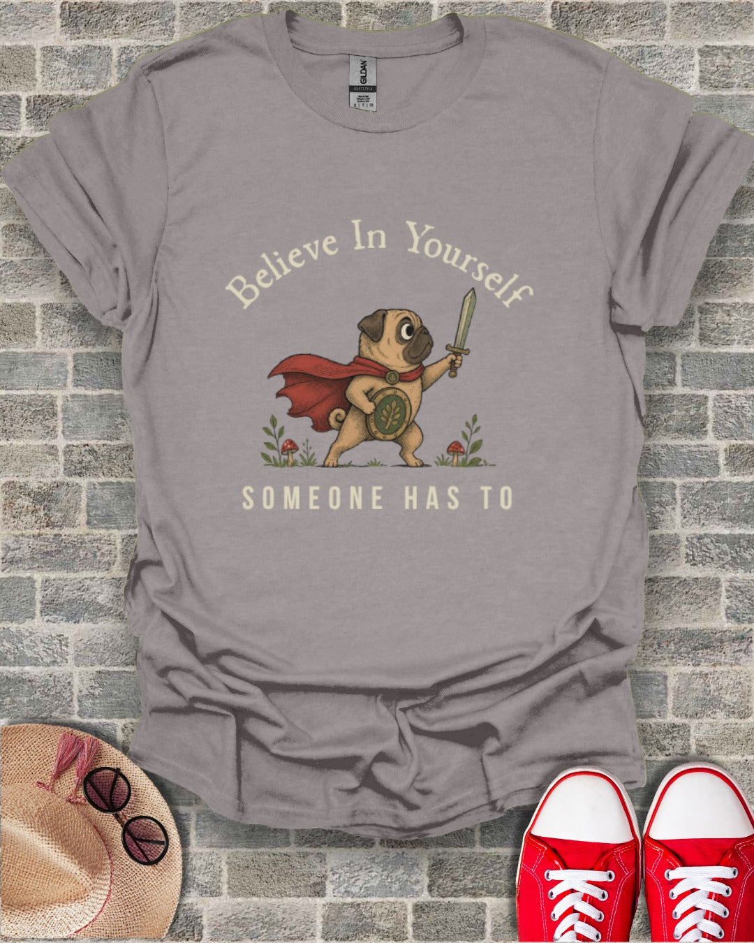 Pug in a cape with a sword and shield, "Believe in yourself, someone has to" text.