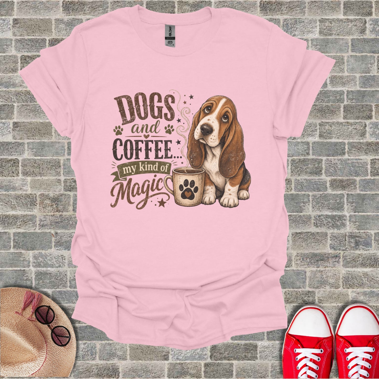 Pink t-shirt with a basset hound and "Dogs and Coffee my kind of Magic" text.