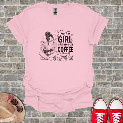 Pink t-shirt with "Just a girl who needs coffee and dogs" graphic.