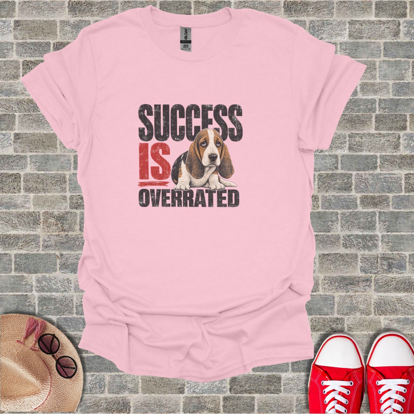 Pink t-shirt with "SUCCESS IS OVERRATED" and sad basset hound graphic.