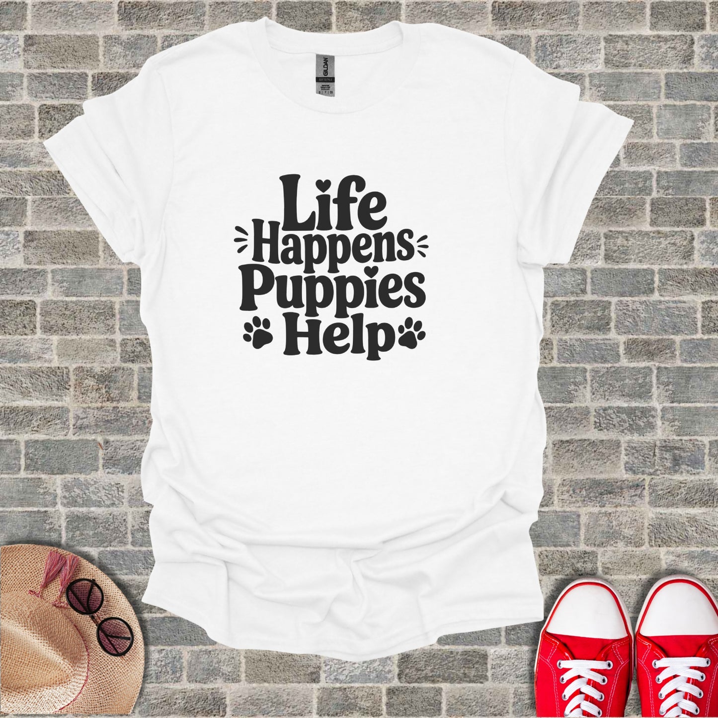 White t-shirt with "Life Happens Puppies Help" text and paw prints.