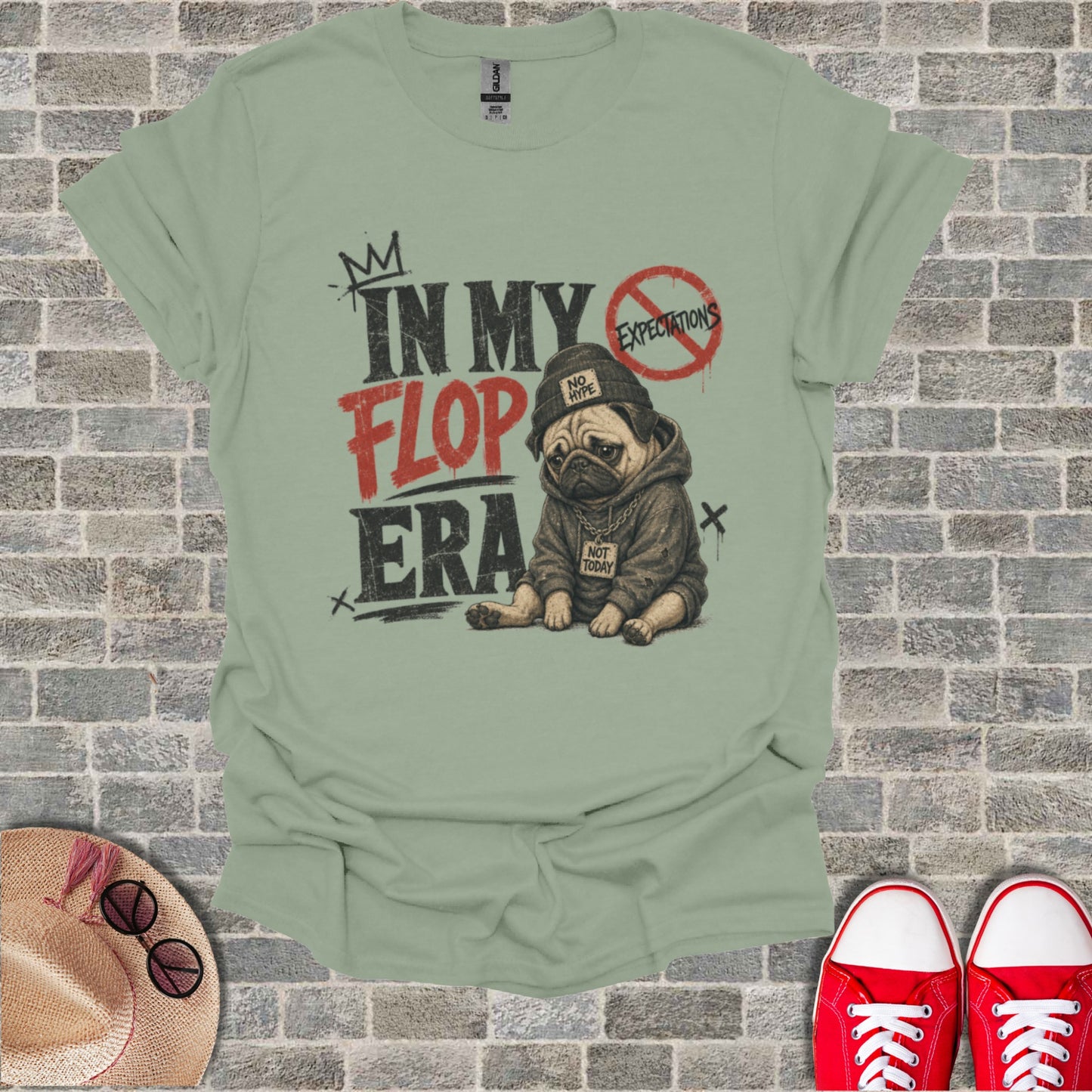 T-shirt with pug in hoodie, "In My Flop Era" text, "Not Today" and "No Hype" on brick background.