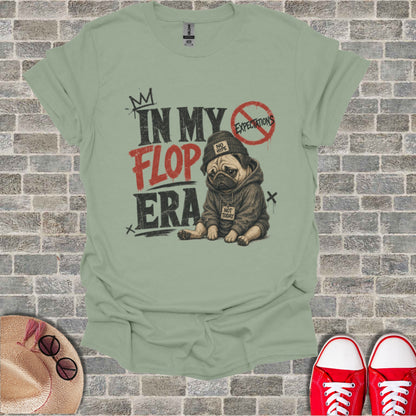 T-shirt with pug in hoodie, "In My Flop Era" text, "Not Today" and "No Hype" on brick background.