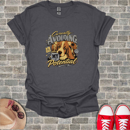 Dark gray t-shirt with a Basset Hound drinking coffee and the text "Currently Avoiding My Potential".