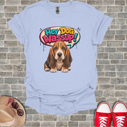 Basset hound puppy with "Hey Dog Wassup!" speech bubble on a light blue t-shirt.