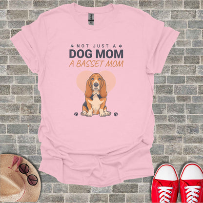 Pink t-shirt with "NOT JUST A DOG MOM A BASSET MOM" text and Basset Hound graphic.