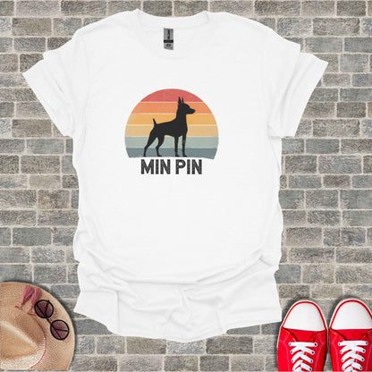 Silhouette of a miniature pinscher dog against a sunset graphic, with "MIN PIN" text.