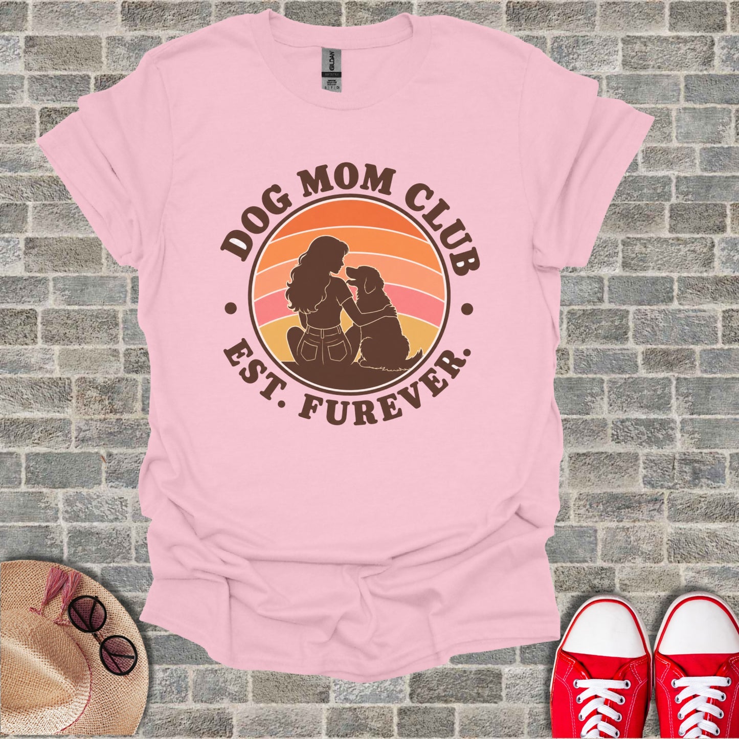 Pink t-shirt with "Dog Mom Club Est. Furever" graphic showing a woman and dog at sunset.