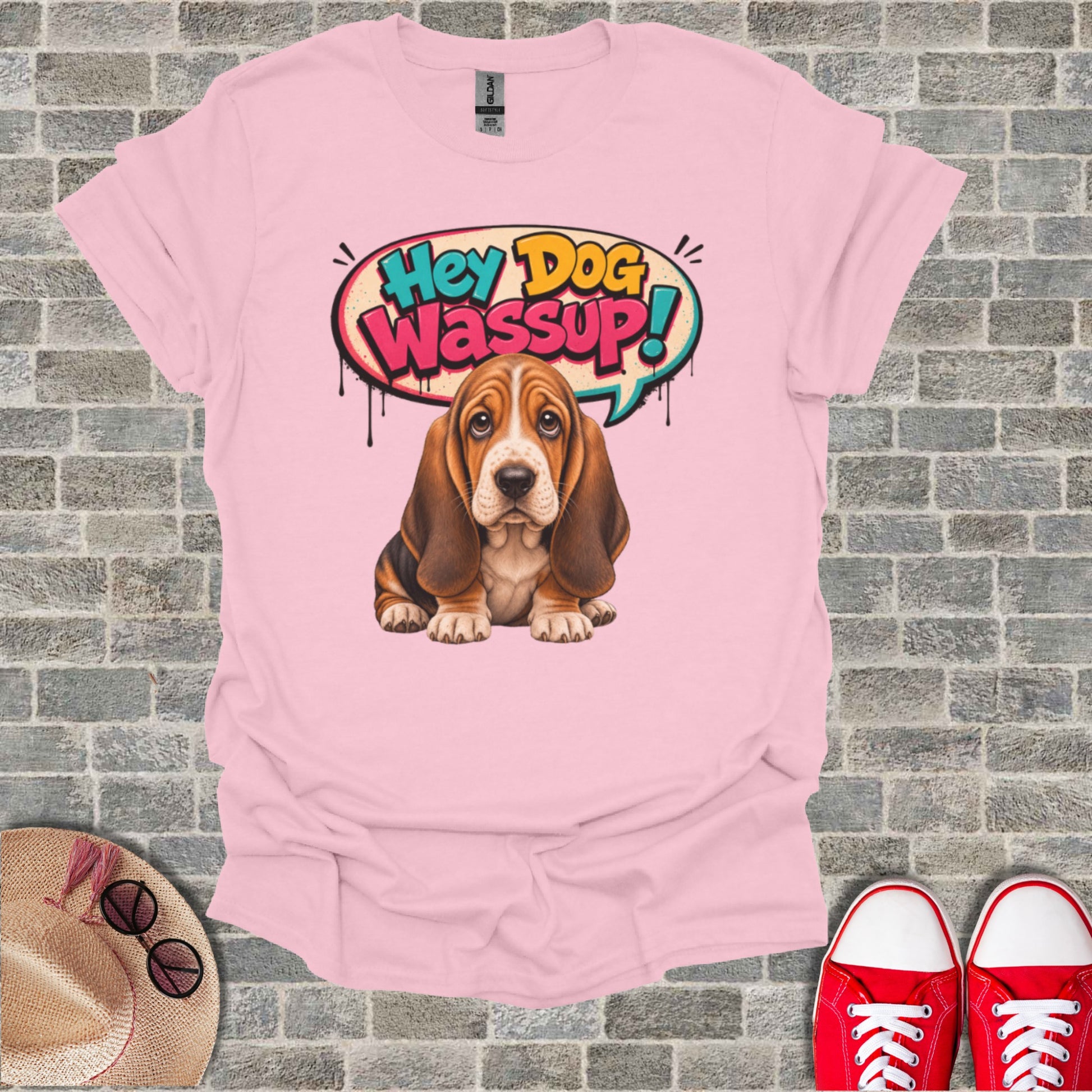 Basset hound wearing a t-shirt with "Hey Dog Wassup!" speech bubble.