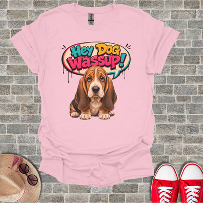 Basset hound wearing a t-shirt with "Hey Dog Wassup!" speech bubble.