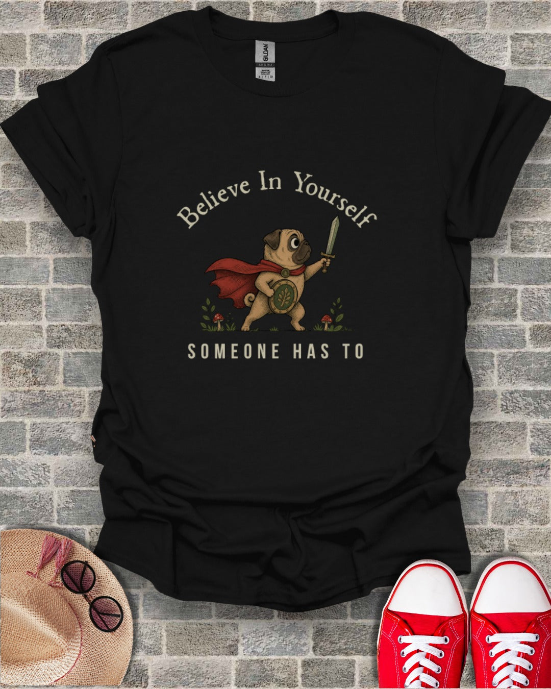 Pug in cape and armor with sword and shield, "Believe In Yourself SOMEONE HAS TO" text.