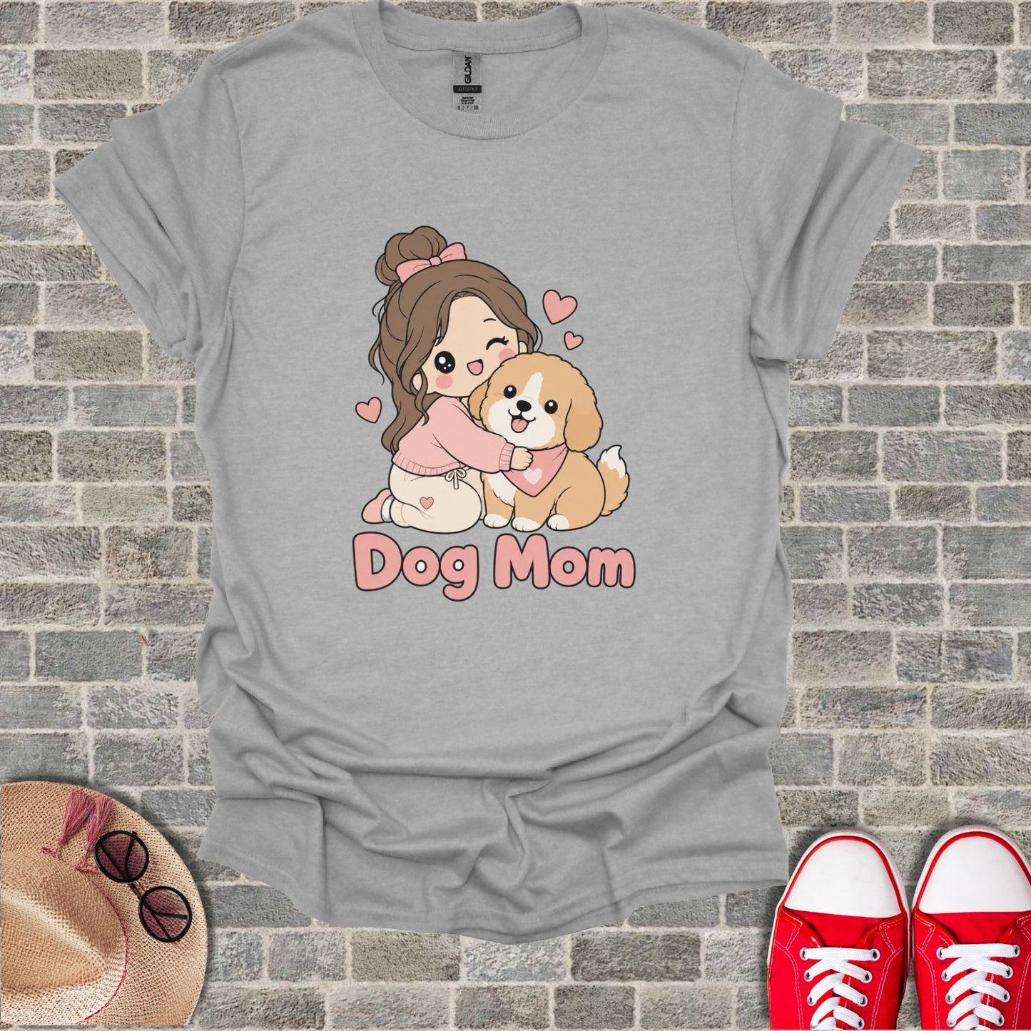 Gray t-shirt with illustration of a girl hugging a dog and text "Dog Mom."