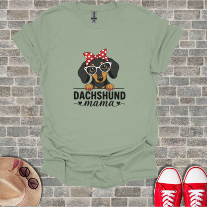 Green t-shirt with cartoon dachshund wearing glasses and red bandana, "Dachshund Mama" text.