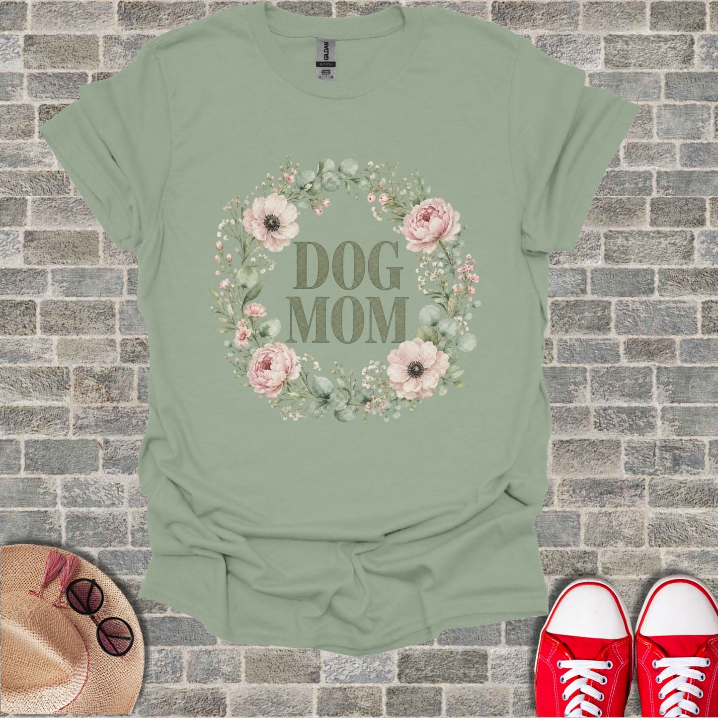 Sage green t-shirt with "DOG MOM" text inside a floral wreath.