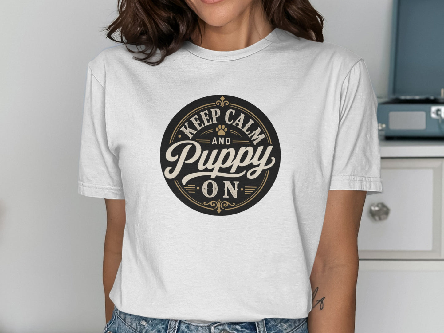 Black and gold text "Keep Calm and Puppy On" on a white t-shirt.