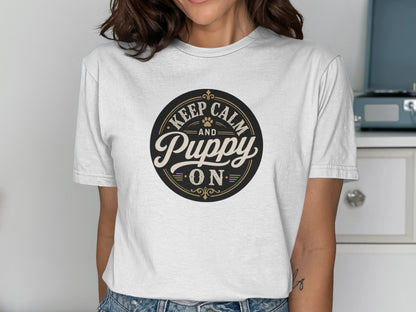 Black and gold text "Keep Calm and Puppy On" on a white t-shirt.