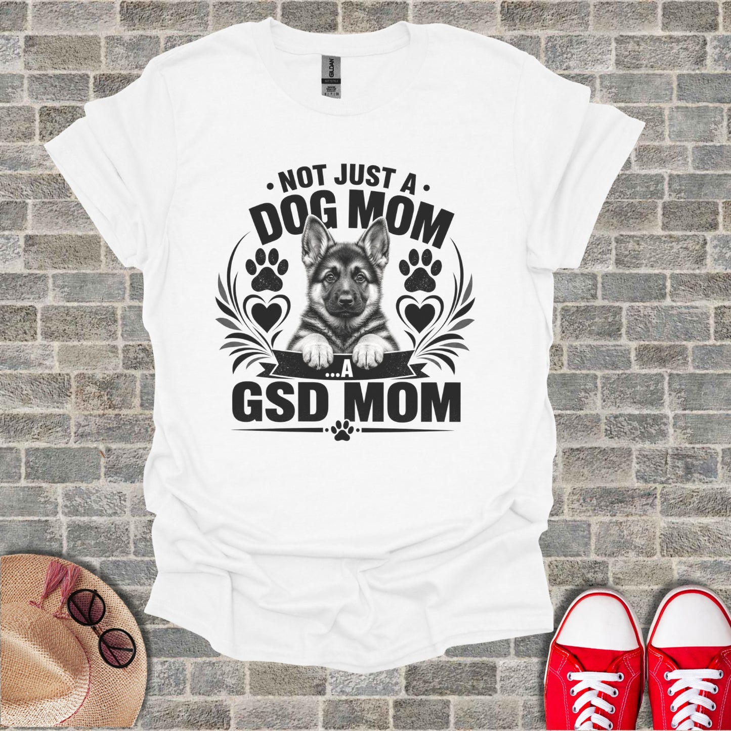 White t-shirt with black graphic: "Not just a Dog Mom...a GSD Mom" and German Shepherd puppy.