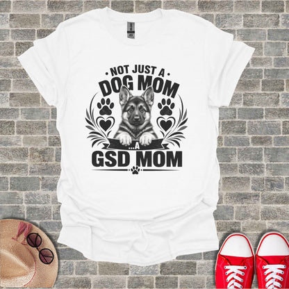White t-shirt with black graphic: "Not just a Dog Mom...a GSD Mom" and German Shepherd puppy.