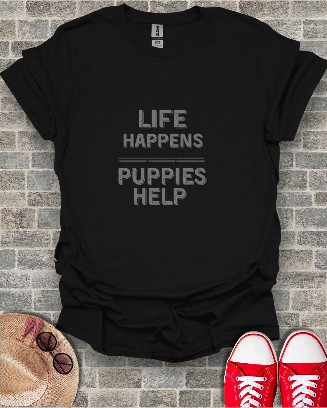 Black t-shirt with gray text "LIFE HAPPENS PUPPIES HELP".