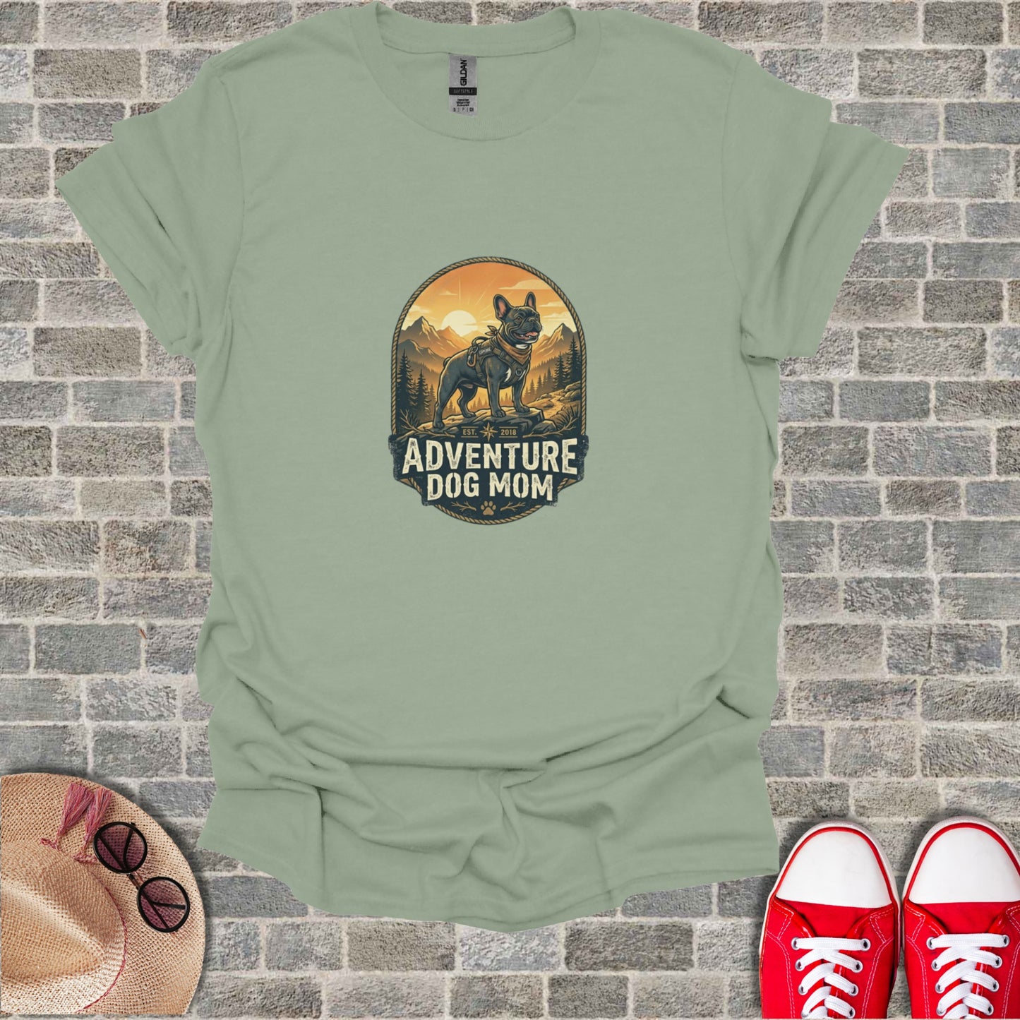 T-shirt graphic: French bulldog in mountain landscape, "Adventure Dog Mom" text.