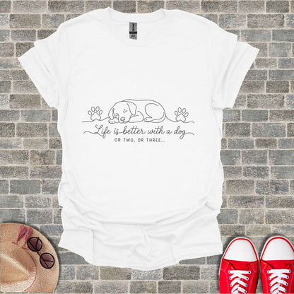 White t-shirt with black line art of a sleeping dog, paw prints, and text.