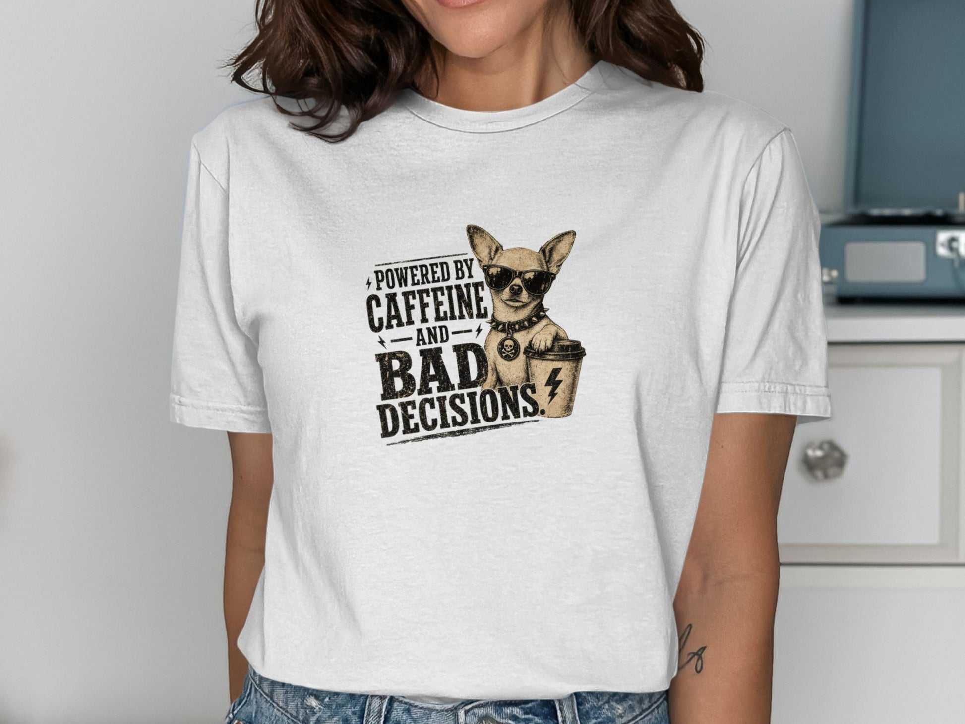 White t-shirt with graphic: chihuahua, coffee cup, and text "Powered by caffeine and bad decisions."