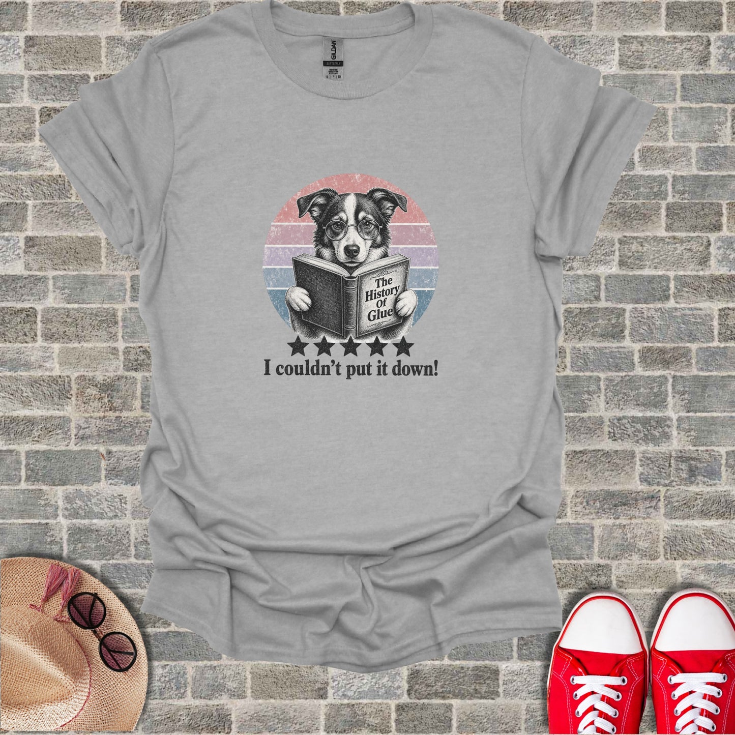 T-shirt with illustration of dog reading a book, "The History of Glue".