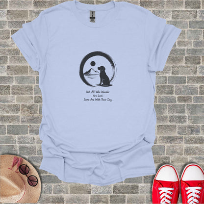 Light blue t-shirt with dog silhouette, moon, sun, and text.