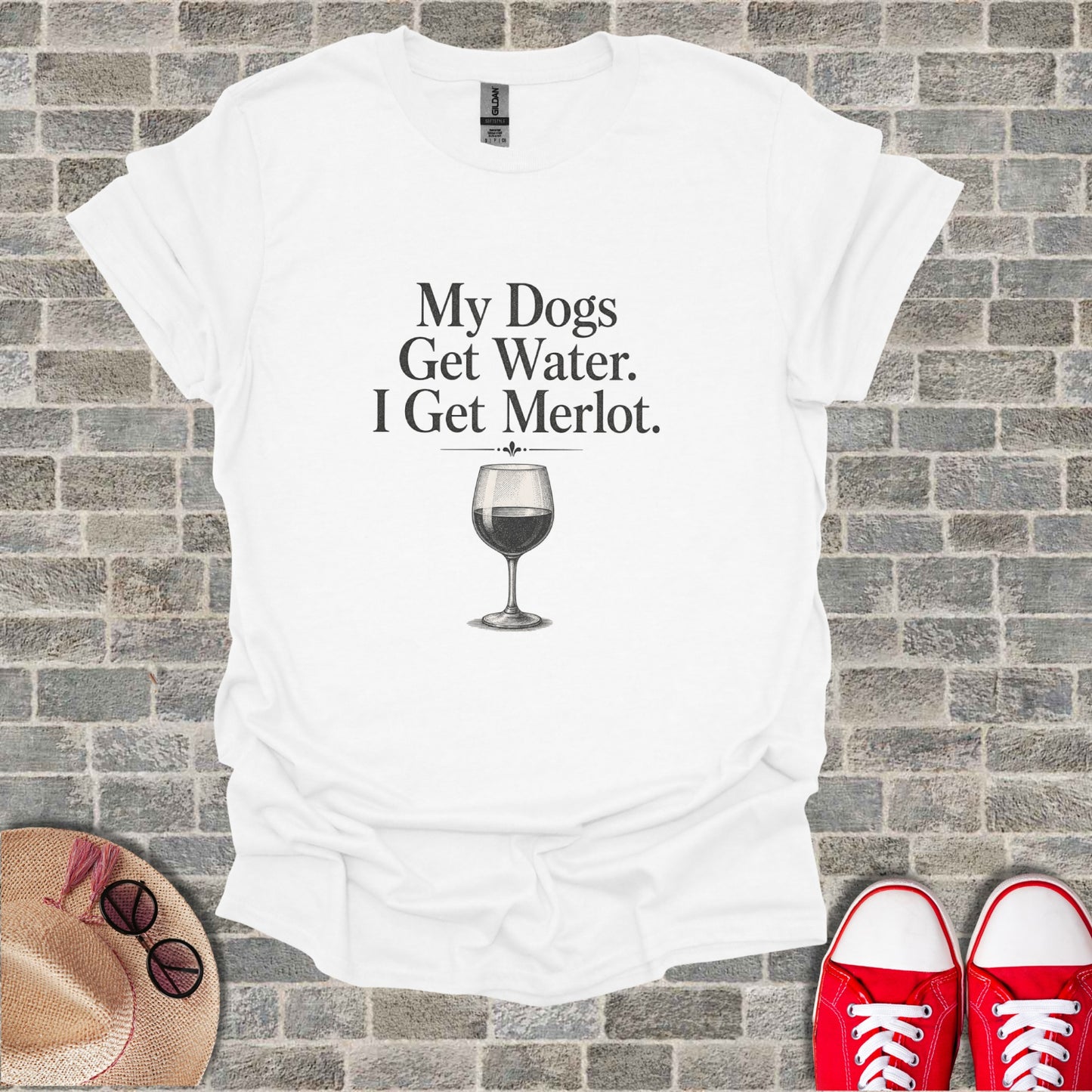 White t-shirt with text "My Dogs Get Water. I Get Merlot." and a wine glass.