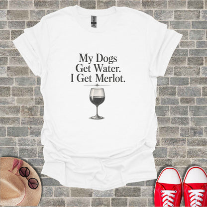 White t-shirt with text "My Dogs Get Water. I Get Merlot." and a wine glass.