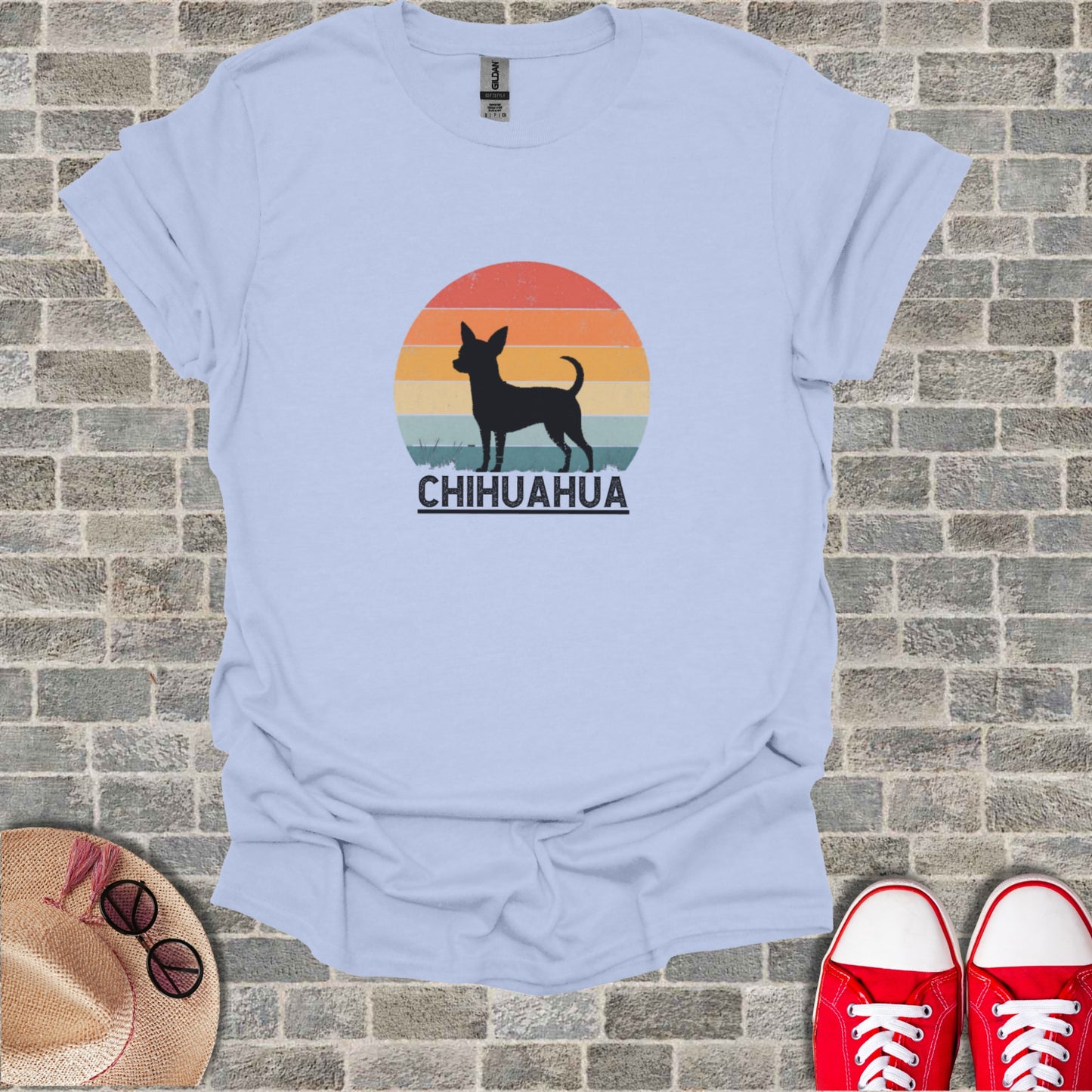 Light blue t-shirt with a black chihuahua silhouette against a sunset graphic and "Chihuahua" text.