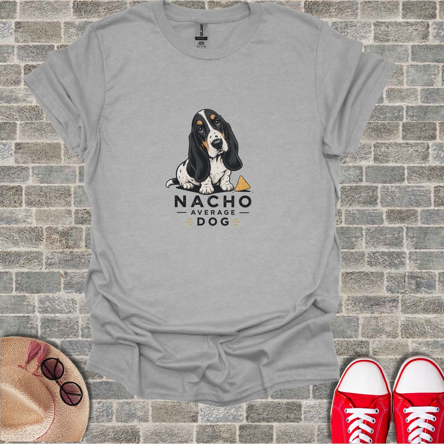 Basset hound wearing a bandana, text "NACHO AVERAGE DOG" with a cheese wedge.