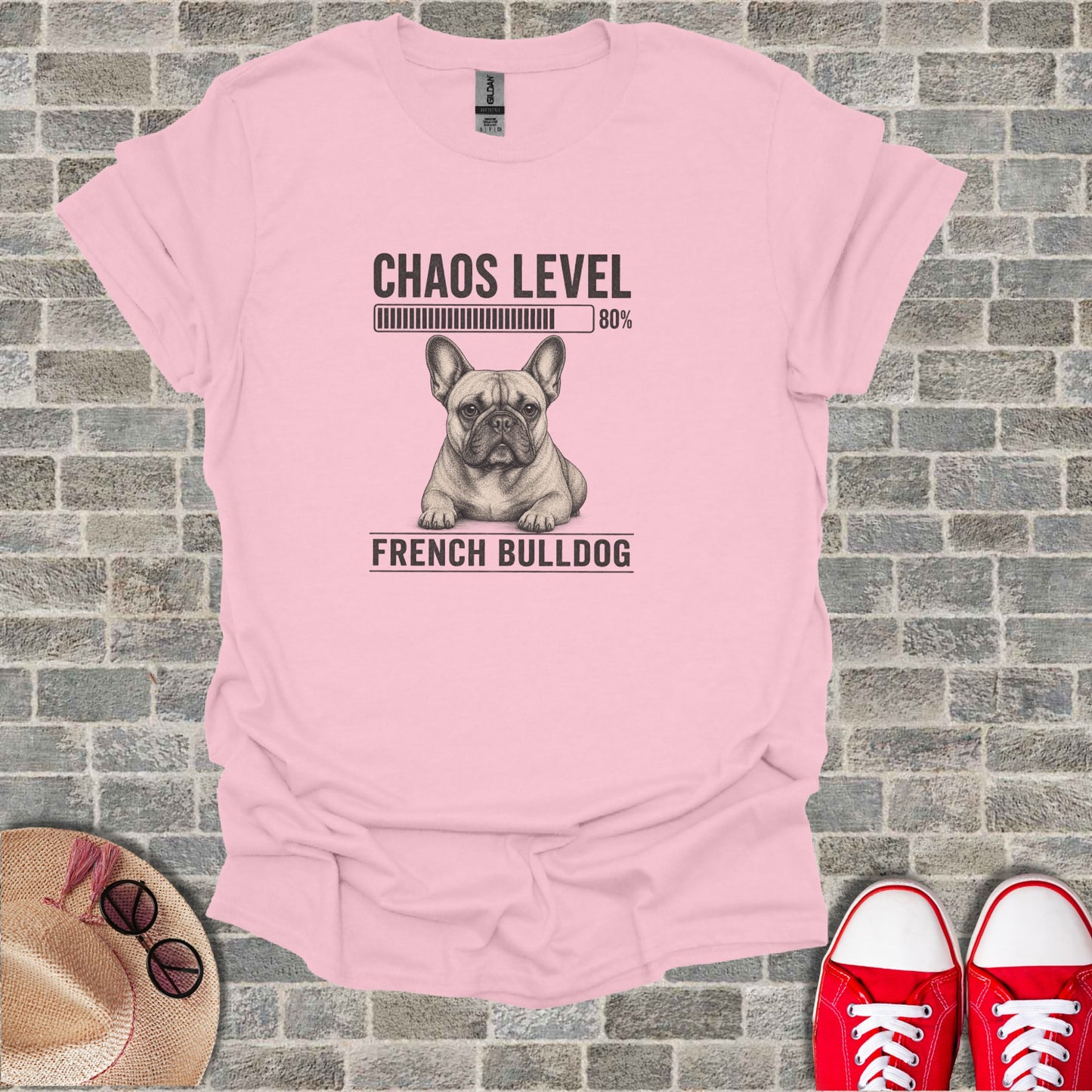 Pink t-shirt with a drawing of a French bulldog and "CHAOS LEVEL 80%" text.