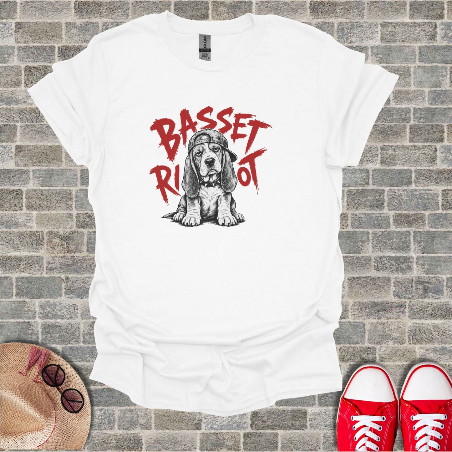 White t-shirt with a sketch of a basset hound wearing a backwards baseball cap.